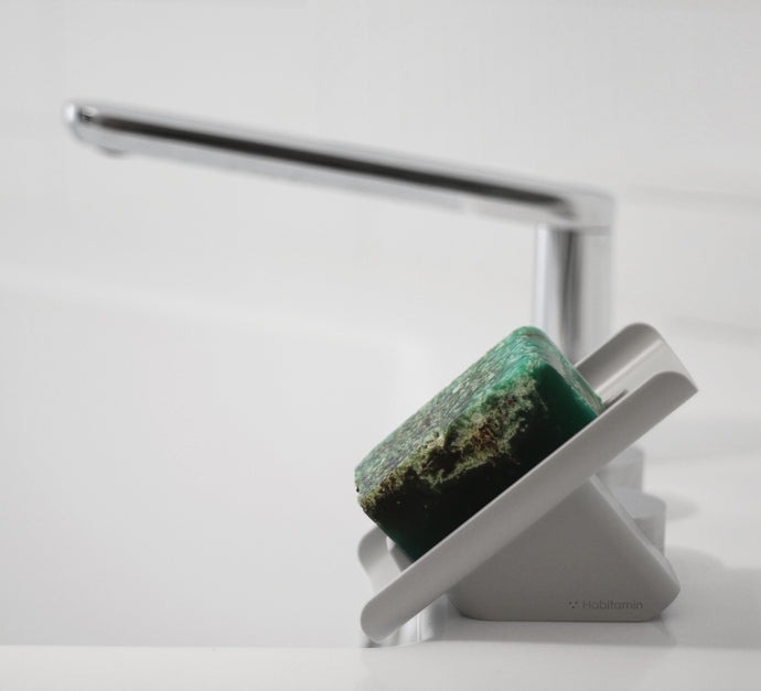 The slanted soap dish, saver, waterfall, drains water into the bathroom sink perfectly
